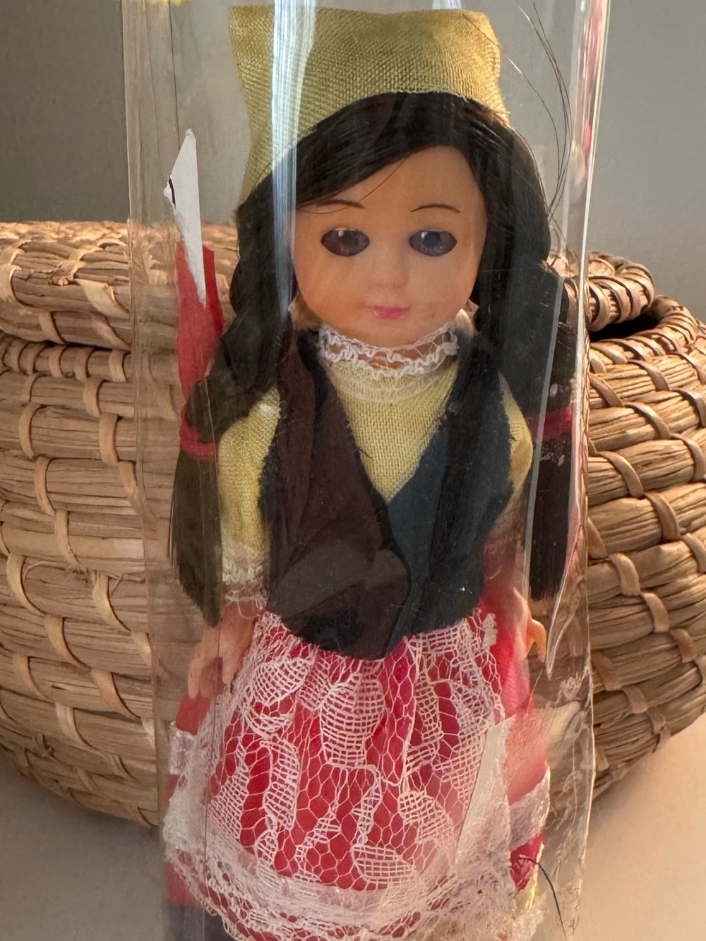 Vintage doll with black hair and red skirt
